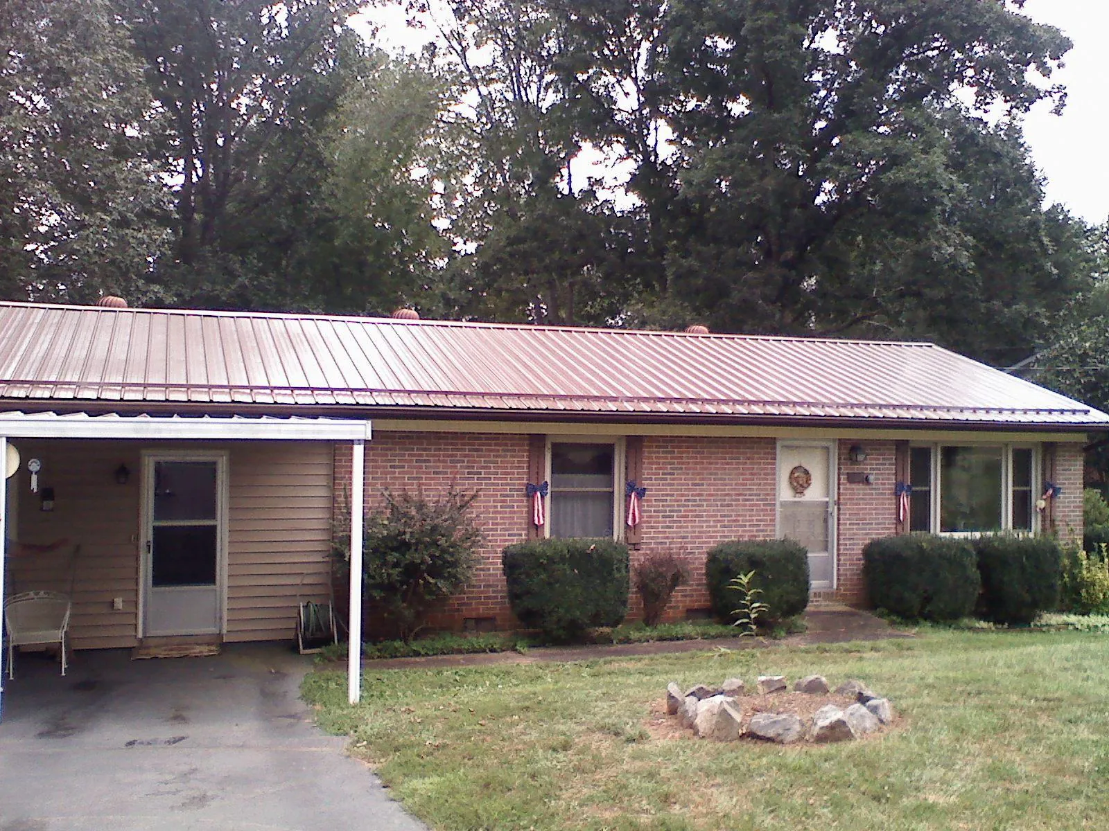 Bronze metal roof and carport on a brick ranch home in Woodstock